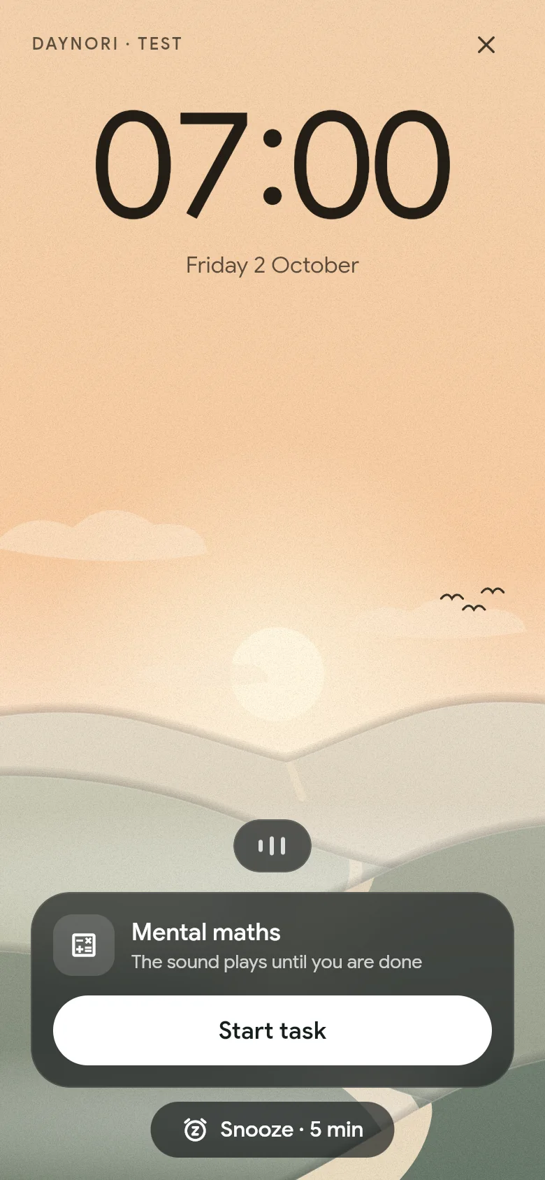 The alarm rings at 07:00 above the morning landscape.